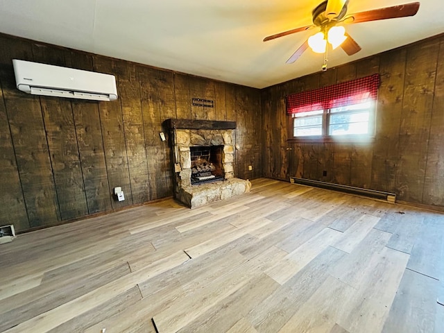 unfurnished living room featuring a wall mounted air conditioner, a baseboard radiator, wooden walls, and light wood-type flooring