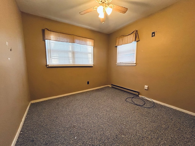 carpeted empty room with ceiling fan, a baseboard radiator, and a wealth of natural light