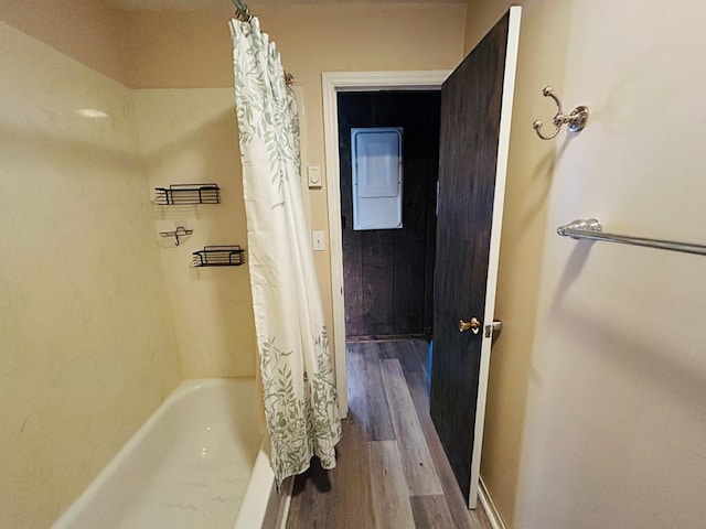 bathroom featuring shower / bath combination with curtain and hardwood / wood-style flooring