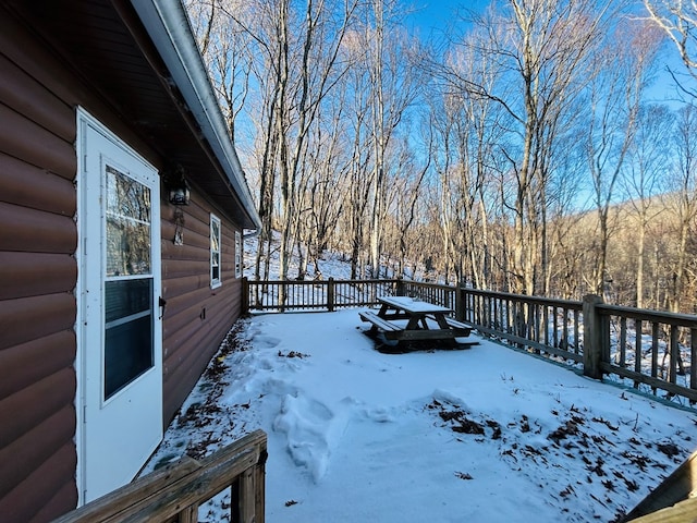 yard layered in snow featuring a deck