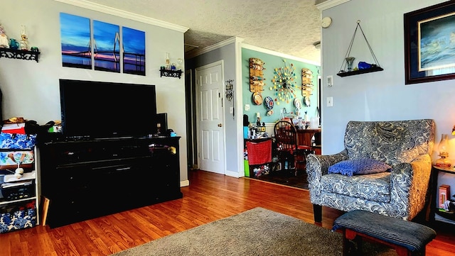 living room with crown molding and wood finished floors