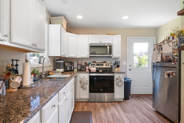 1048 Preston Dr, Radford, VA 24141 - kitchen with stainless steel appliances, white cabinetry, light wood finished floors, dark stone counters, and recessed lighting