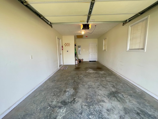 garage with electric panel, baseboards, and a garage door opener