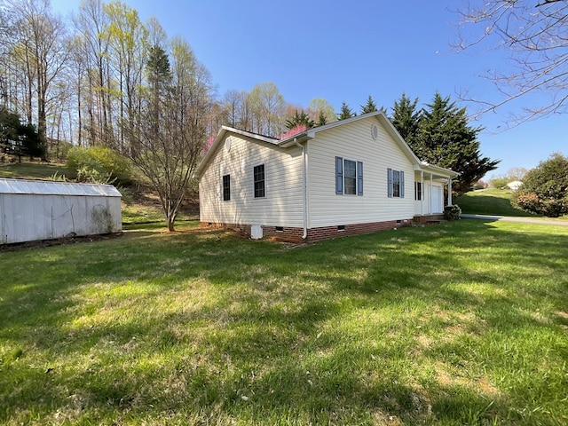 view of home's exterior featuring a lawn and crawl space