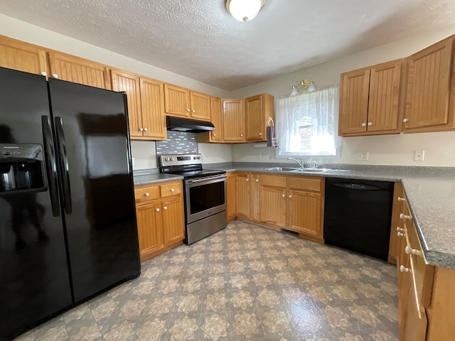 kitchen featuring under cabinet range hood, dark countertops, a sink, black appliances, and a textured ceiling