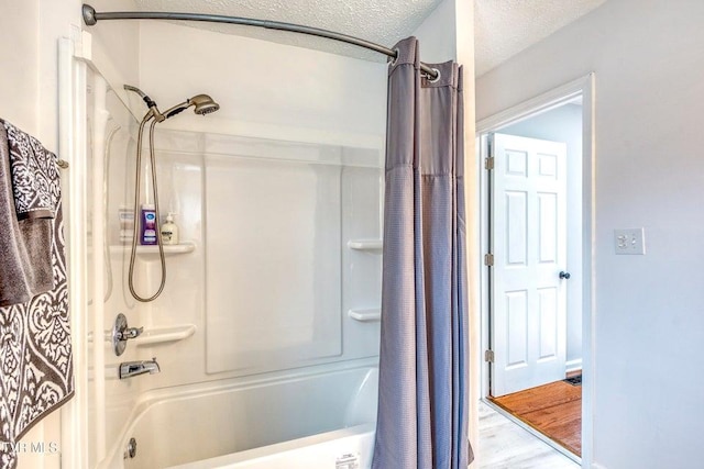 full bath featuring shower / tub combo and wood finished floors