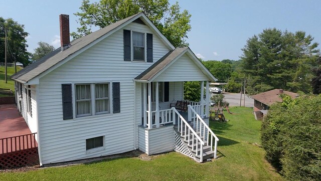 419 Adams St, Marion, VA 24354 - bungalow-style house featuring a chimney, covered porch, and a front lawn