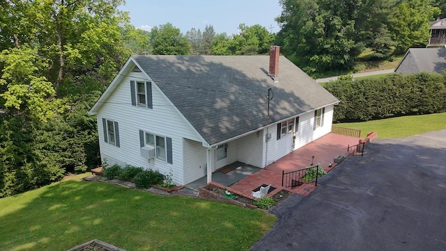419 Adams St, Marion, VA 24354 - view of front of home featuring a chimney, a front lawn, a shingled roof, driveway, and a patio