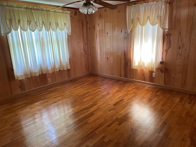 419 Adams St, Marion, VA 24354 - spare room with wood finished floors, a ceiling fan, and wooden walls
