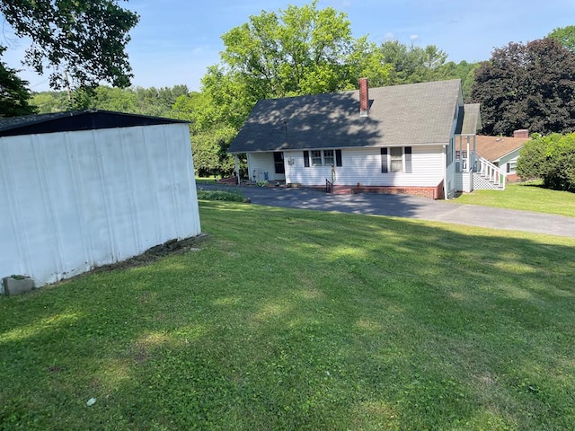 419 Adams St, Marion, VA 24354 - view of front of house with a chimney, a front yard, and a shed