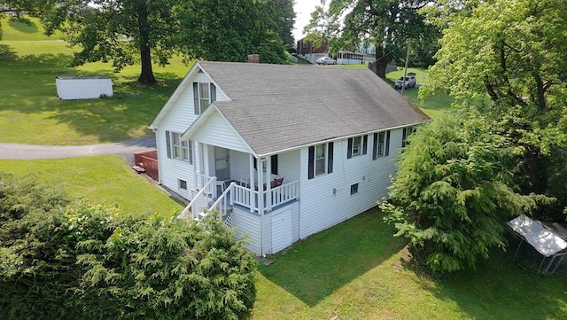 419 Adams St, Marion, VA 24354 - view of front of house with covered porch, roof with shingles, a front lawn, a chimney, and view of wooded area