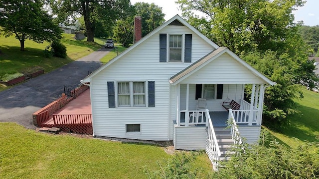419 Adams St, Marion, VA 24354 - bungalow-style home featuring a porch, stairway, a front lawn, and a chimney