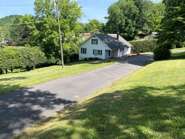 419 Adams St, Marion, VA 24354 - view of front facade with a chimney, a front lawn, and driveway