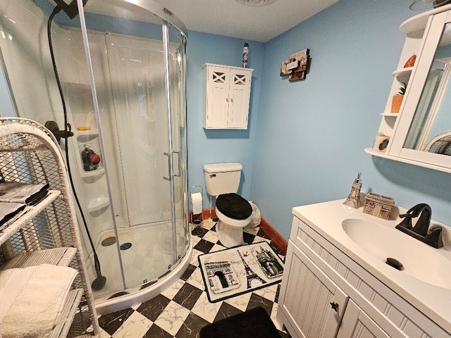 bathroom with a stall shower, baseboards, toilet, tile patterned floors, and vanity