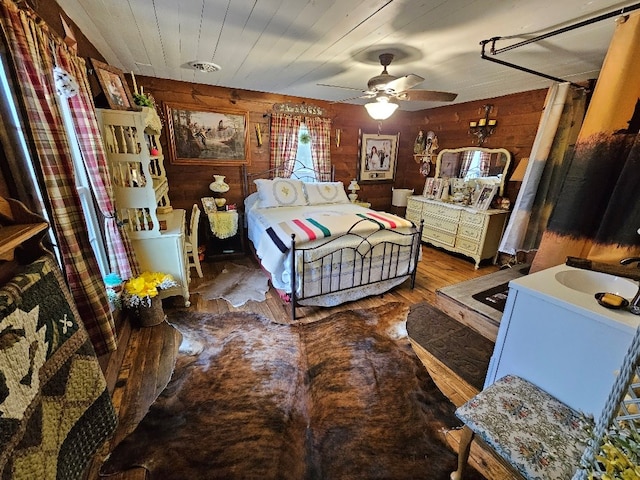 bedroom featuring wood finished floors, wood ceiling, and wooden walls