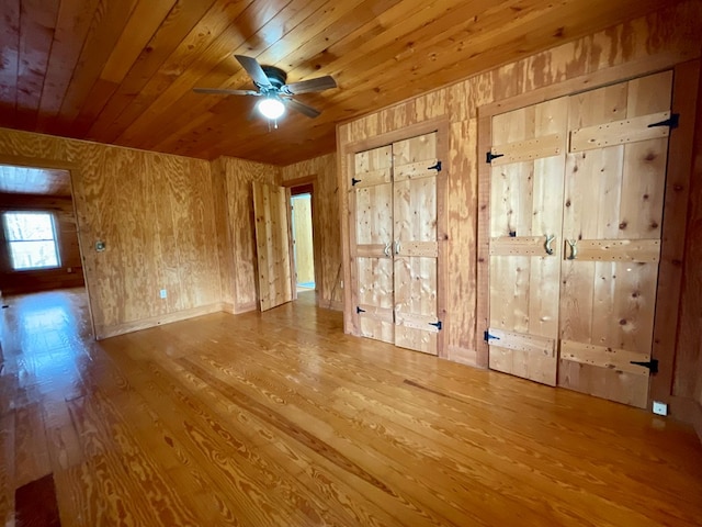 spare room with a ceiling fan, wooden ceiling, and wood finished floors