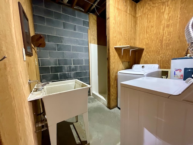 laundry area with water heater, laundry area, and washer and dryer