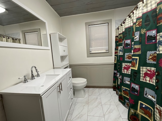 full bathroom featuring vanity, a shower with shower curtain, toilet, and marble finish floor