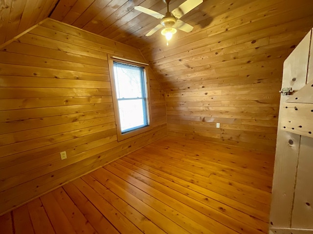 bonus room featuring light wood finished floors, wood walls, wooden ceiling, and vaulted ceiling