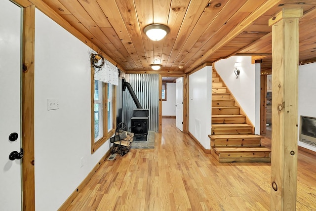 hallway featuring light hardwood / wood-style floors, heating unit, and wood ceiling