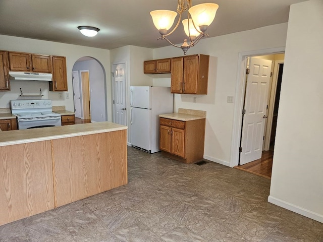 kitchen featuring arched walkways, white appliances, brown cabinetry, and under cabinet range hood