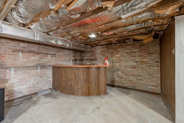 bar featuring brick wall and concrete flooring