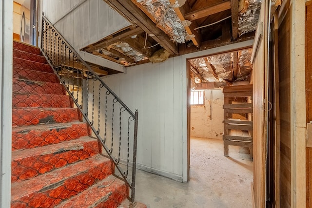 stairs featuring concrete flooring