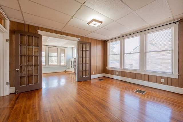 unfurnished room featuring a paneled ceiling and wood-type flooring