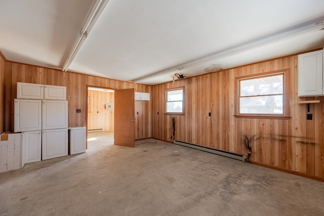 empty room with a baseboard radiator, a healthy amount of sunlight, and light colored carpet