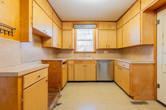 kitchen with sink, dishwasher, and light brown cabinets