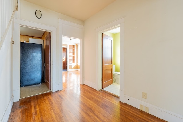 hallway with wood-type flooring