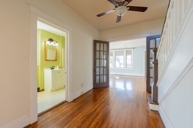 hallway with sink and wood-type flooring