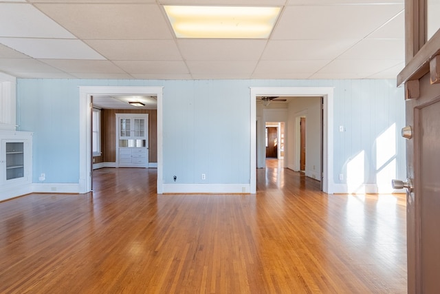 spare room featuring hardwood / wood-style flooring and a paneled ceiling