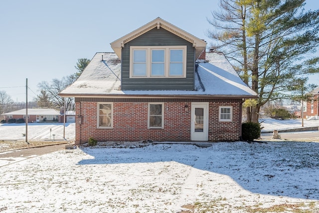 view of snow covered rear of property