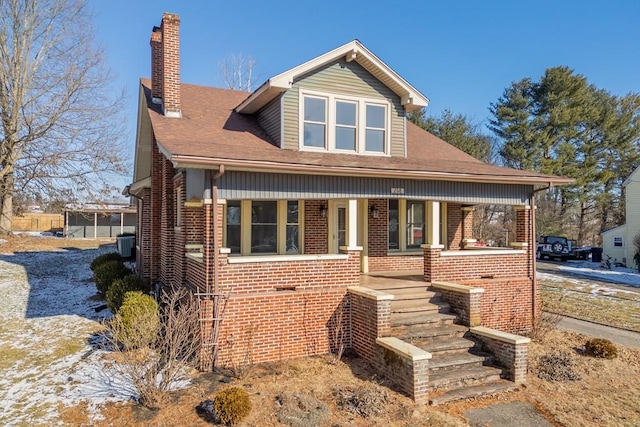 view of front of house featuring a porch and central air condition unit