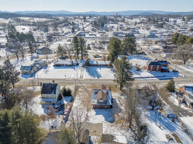 snowy aerial view featuring a mountain view