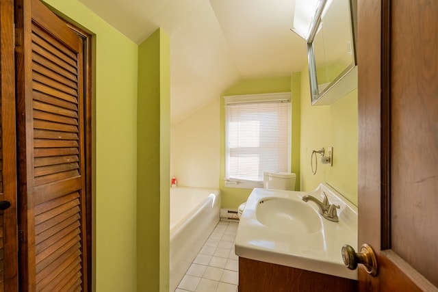 bathroom with tile patterned flooring, vanity, a bathing tub, and vaulted ceiling