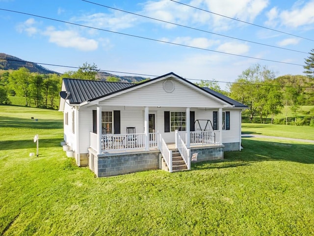 3003 Freestone Valley Rd, Tannersville, VA 24377 - view of front of home featuring a porch, a front lawn, and metal roof