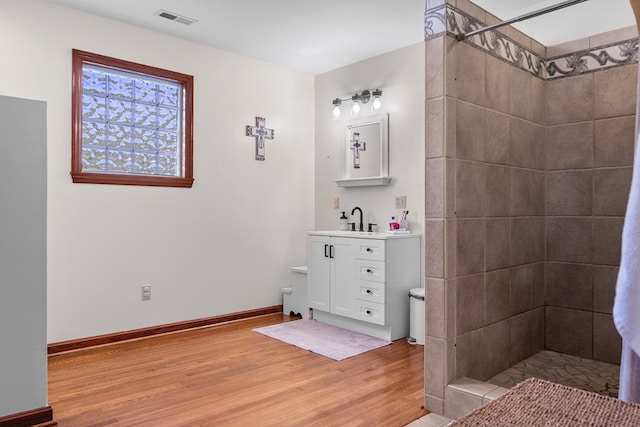 3003 Freestone Valley Rd, Tannersville, VA 24377 - full bathroom with wood finished floors, a tile shower, vanity, and baseboards