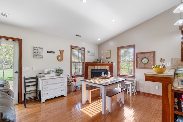 3003 Freestone Valley Rd, Tannersville, VA 24377 - dining space with lofted ceiling, light wood-style floors, a tile fireplace, baseboards, and recessed lighting