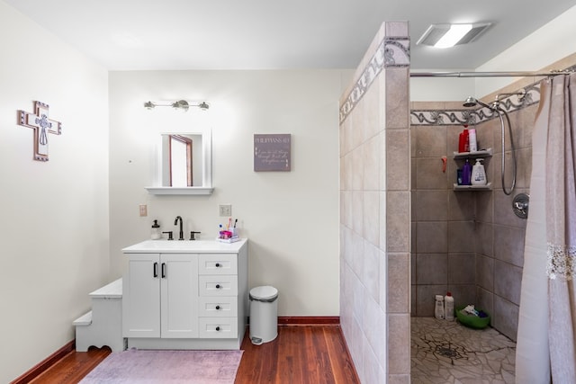 3003 Freestone Valley Rd, Tannersville, VA 24377 - bathroom featuring tiled shower, wood finished floors, baseboards, and vanity