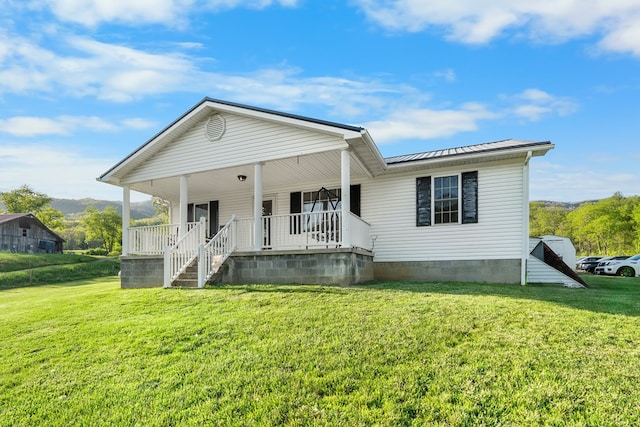 3003 Freestone Valley Rd, Tannersville, VA 24377 - view of front of house featuring covered porch, a front yard, metal roof, and a standing seam roof