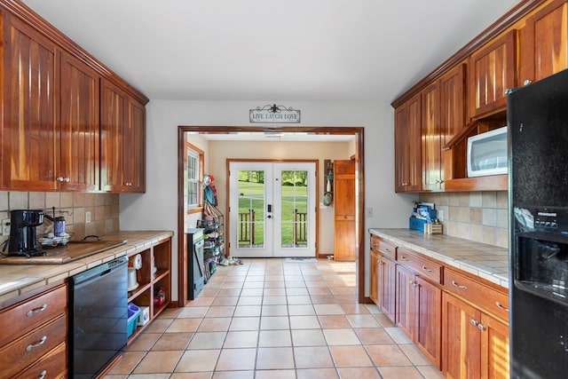 3003 Freestone Valley Rd, Tannersville, VA 24377 - kitchen with black appliances, tile countertops, backsplash, and light tile patterned floors
