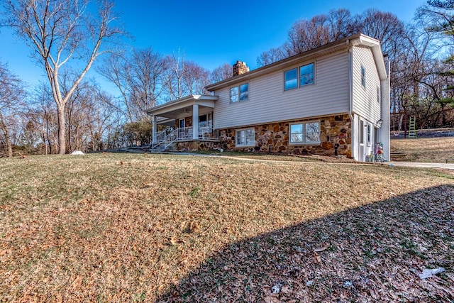 view of front of property featuring covered porch and a front lawn