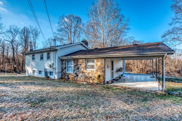 back of property with a carport