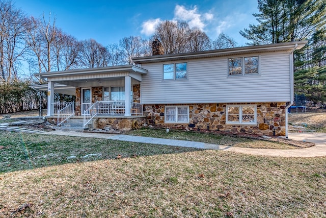 split level home featuring a front yard and covered porch