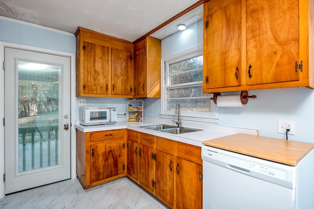 kitchen featuring white appliances and sink