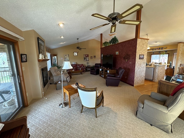 611 Look Ave, Marion, VA 24354 - living room with ceiling fan, vaulted ceiling, a glass covered fireplace, a textured ceiling, and light carpet
