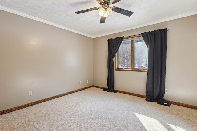 unfurnished room with crown molding, carpet flooring, ceiling fan, a textured ceiling, and baseboards