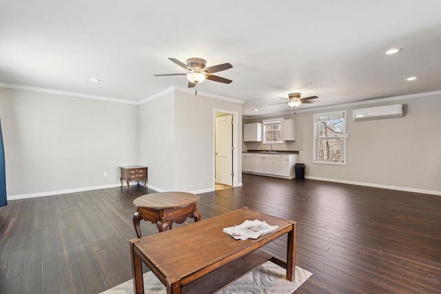 living area featuring baseboards, ornamental molding, dark wood-style flooring, an AC wall unit, and recessed lighting